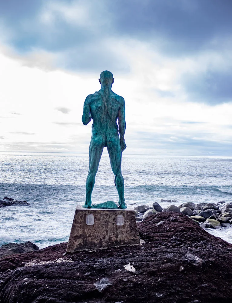 Bronze fisherman statue facing the sea, Madeira, Portugal
